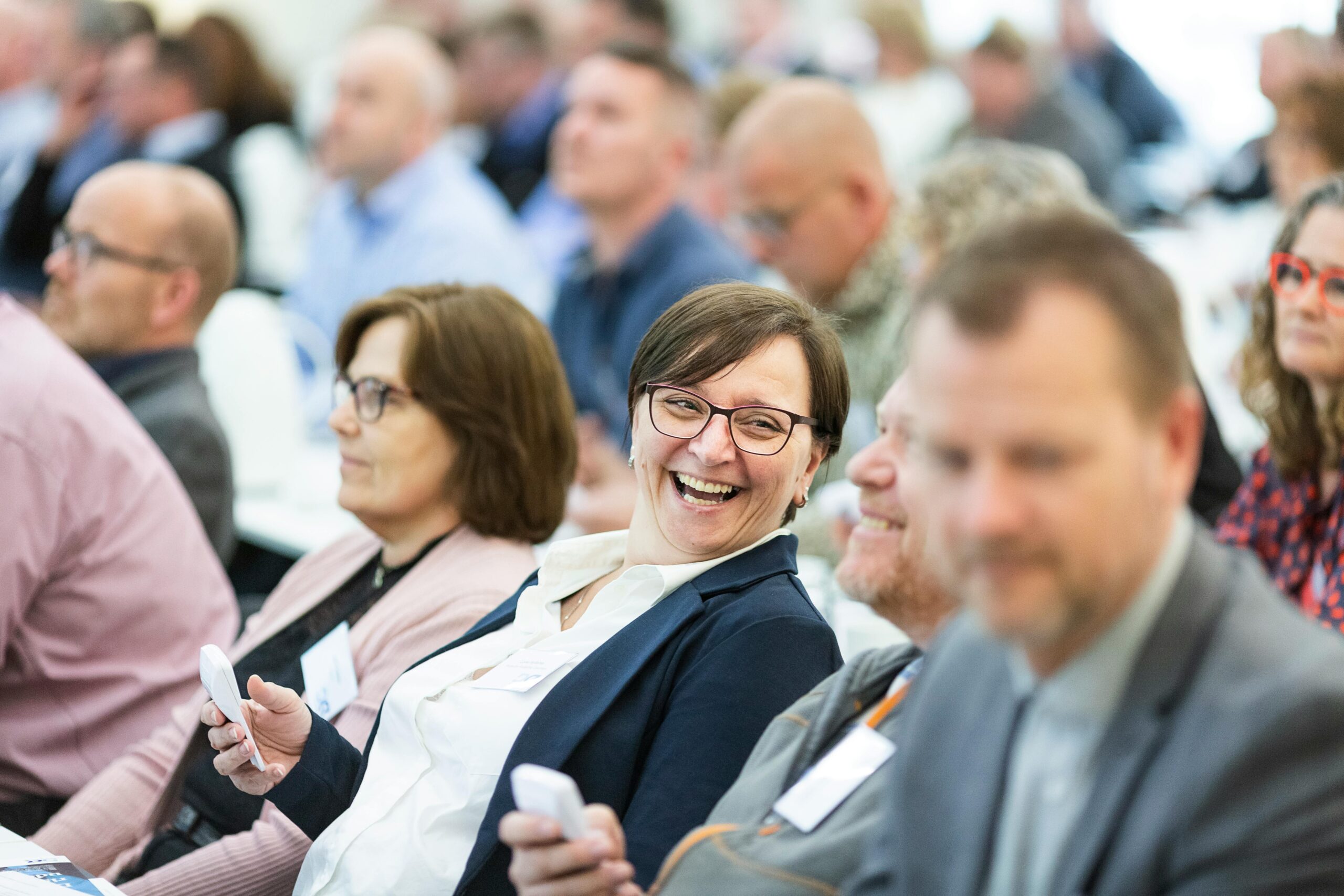 Smiling attendees at a business event for results-driven product brands